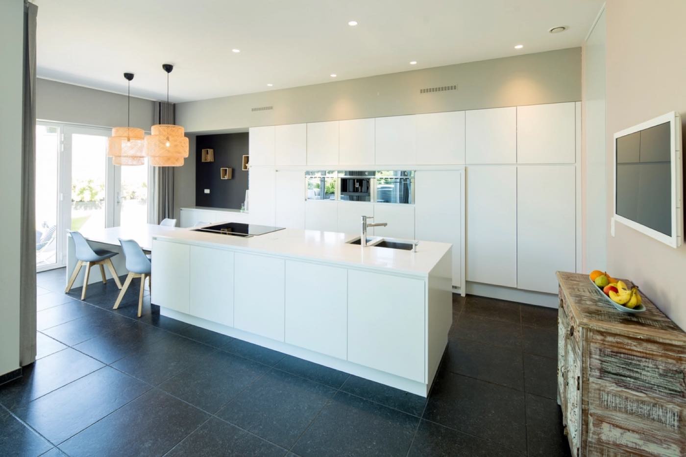 A bright kitchen with clear counters, wiped cabinet fronts and a mopped floor.